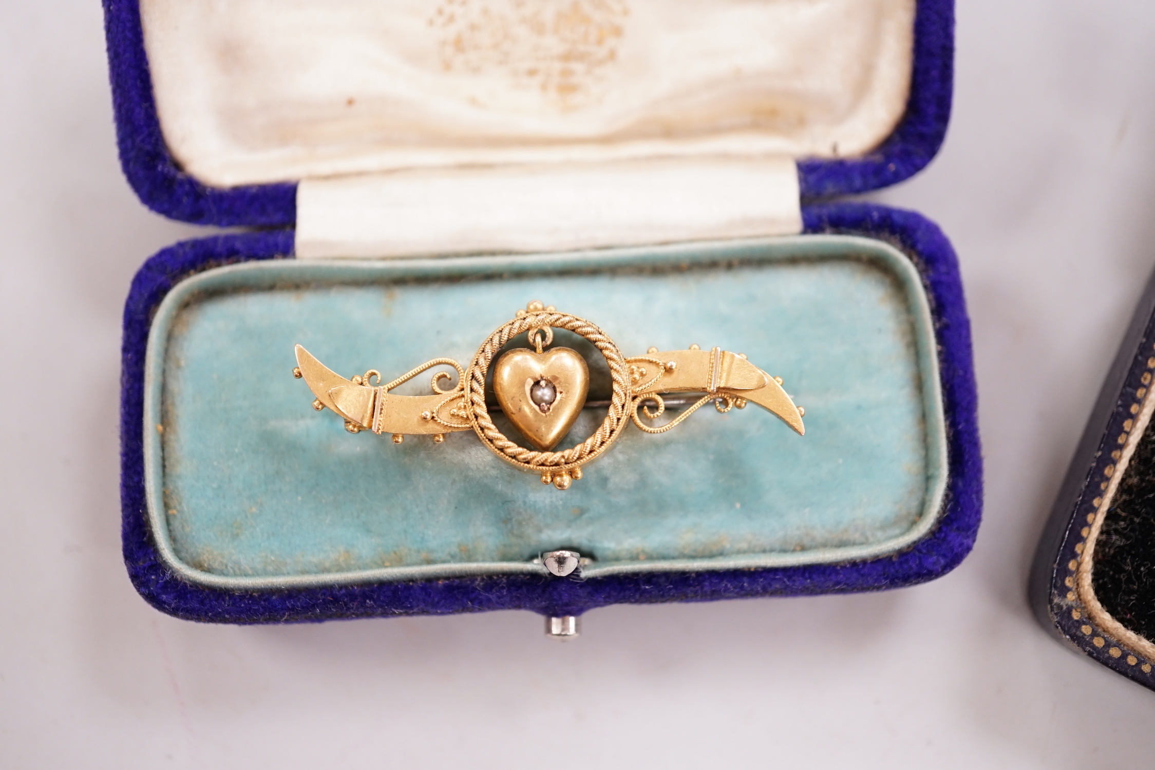 An Edwardian 15ct gold and seed peal set heart drop bar brooch, 40mm, gross weight 2.7 grams, two other yellow metal and gem set bar brooches and a Victorian citrine set brooch.